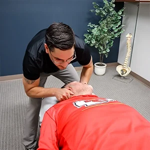 Chiropractor Basehor KS Dennis Lindsay Adjusting Athletes Neck