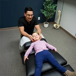 Chiropractor Basehor KS Dennis Lindsay Adjusting Child